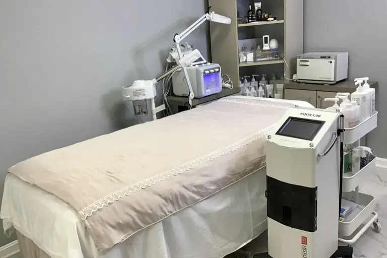 Treatment room with facial bed, steamer and hydrafacial equipment
